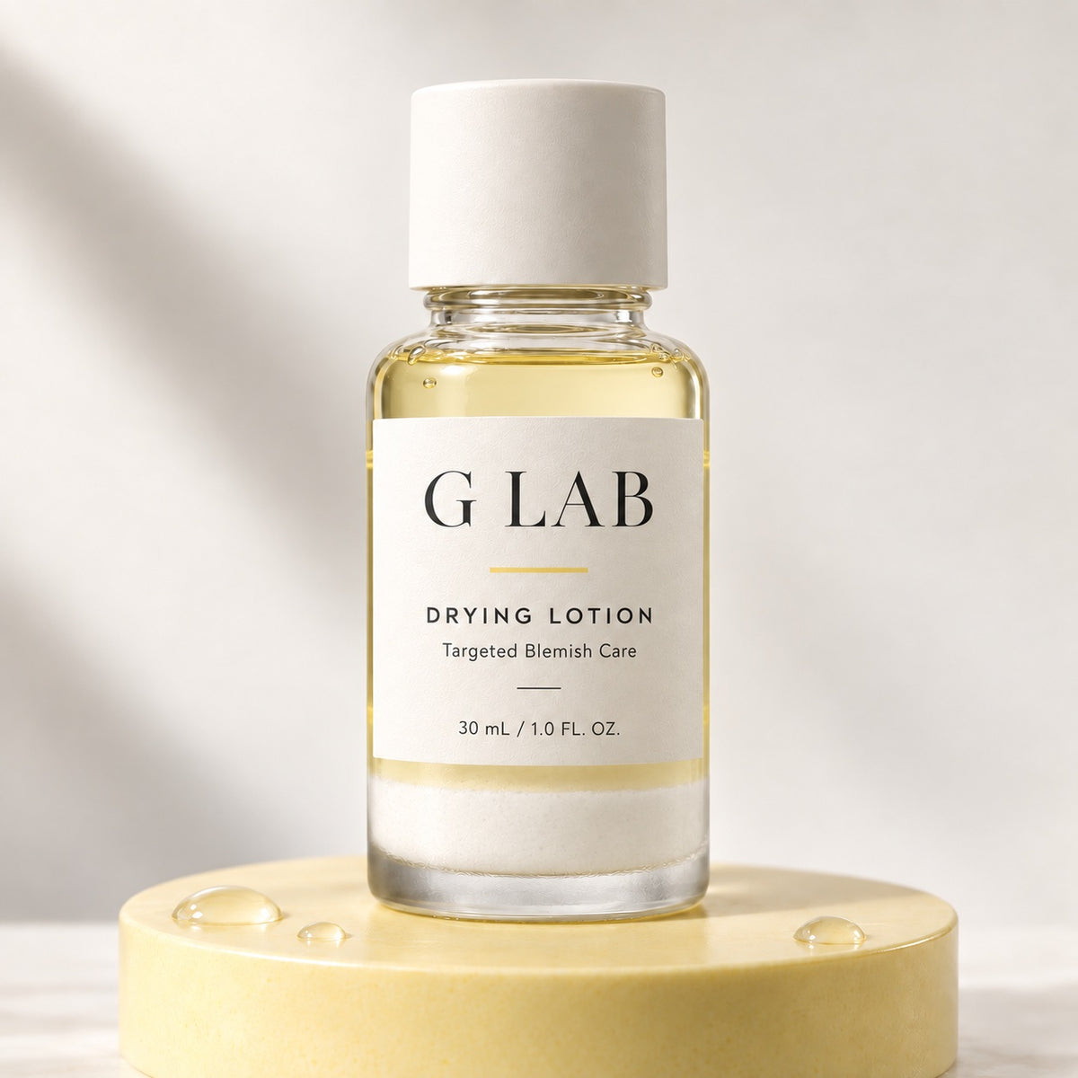 G Lab Drying Lotion 30ml bottle with white sediment on a yellow stand