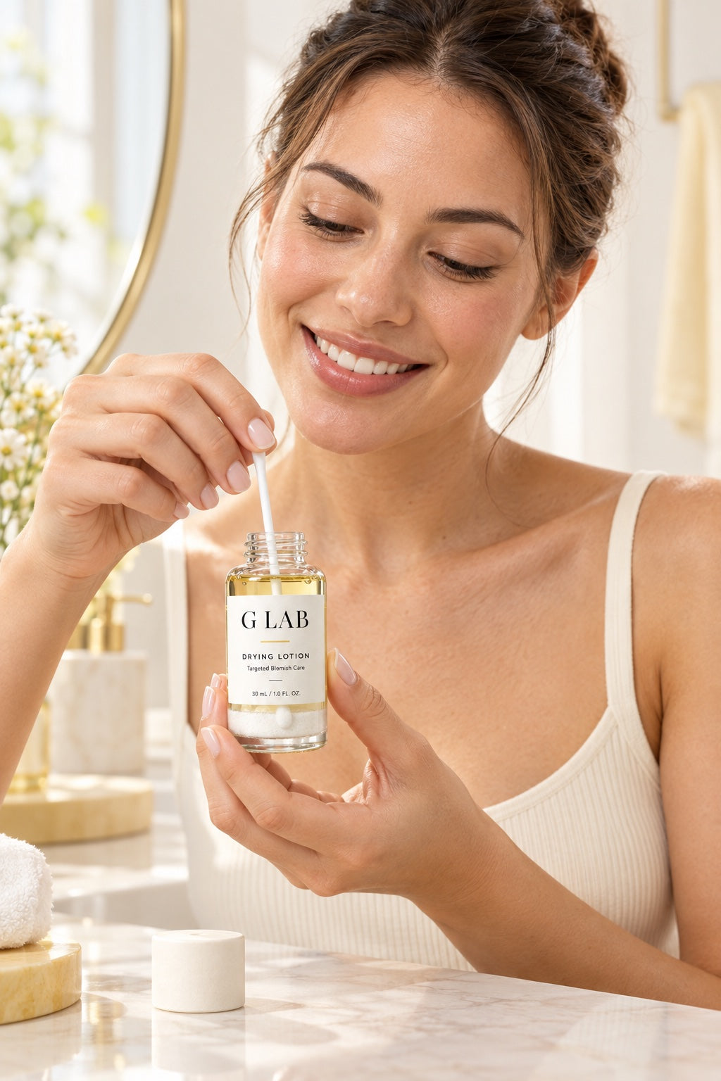 Woman dipping a cotton swab into G Lab Drying Lotion